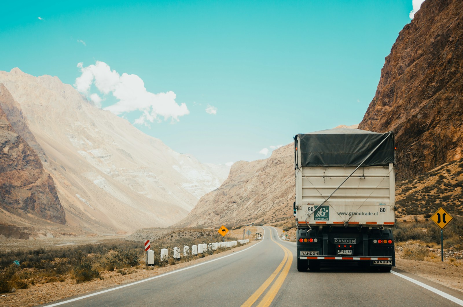 Truck moving through a mountain road as a freight service placeholder